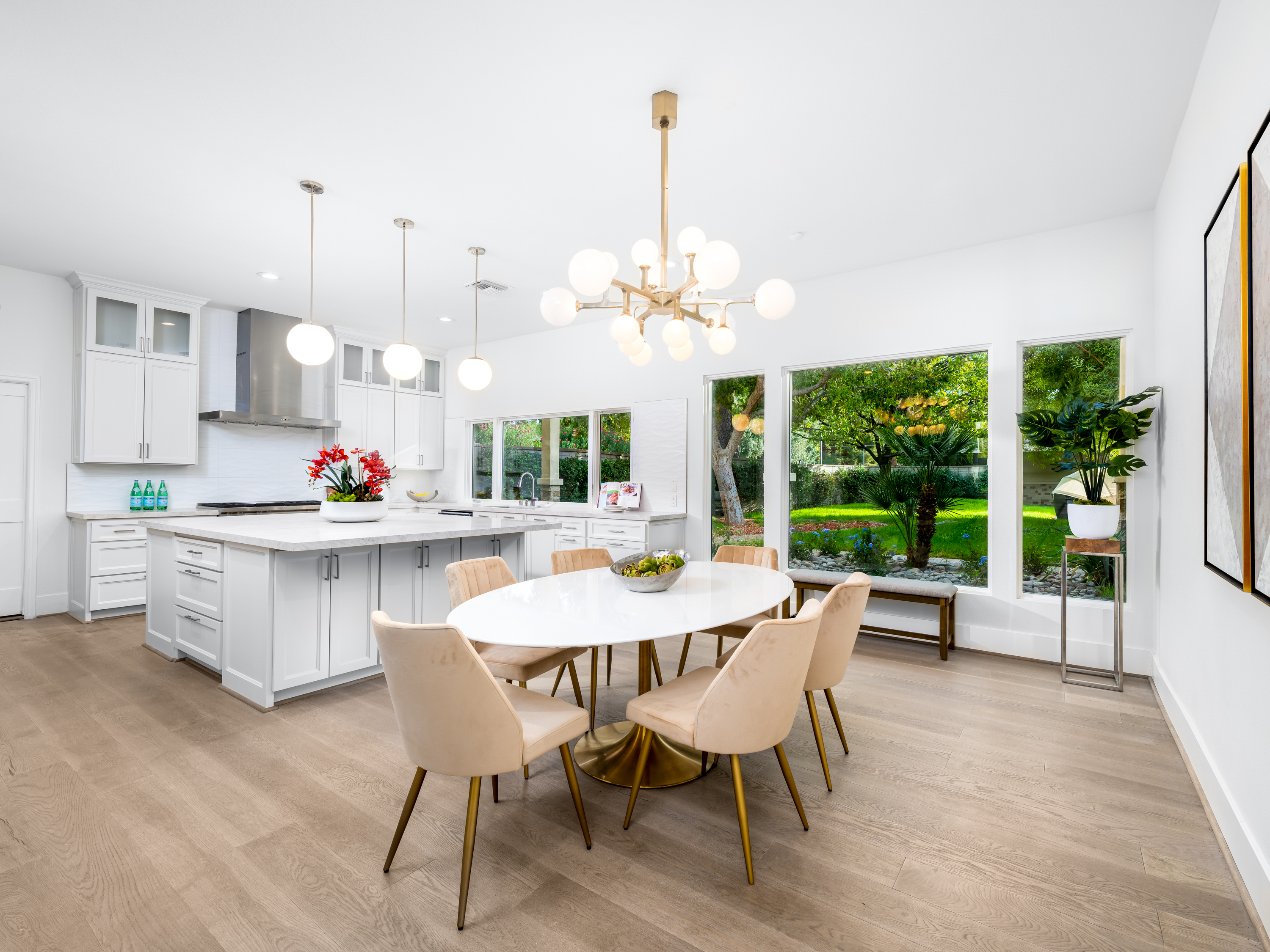 Kitchen at a Stately open contemporary home in Las Vegas (2327 AD) — vaulted ceiling, central fireplace, faceted metallic coffee table, blue accent art.