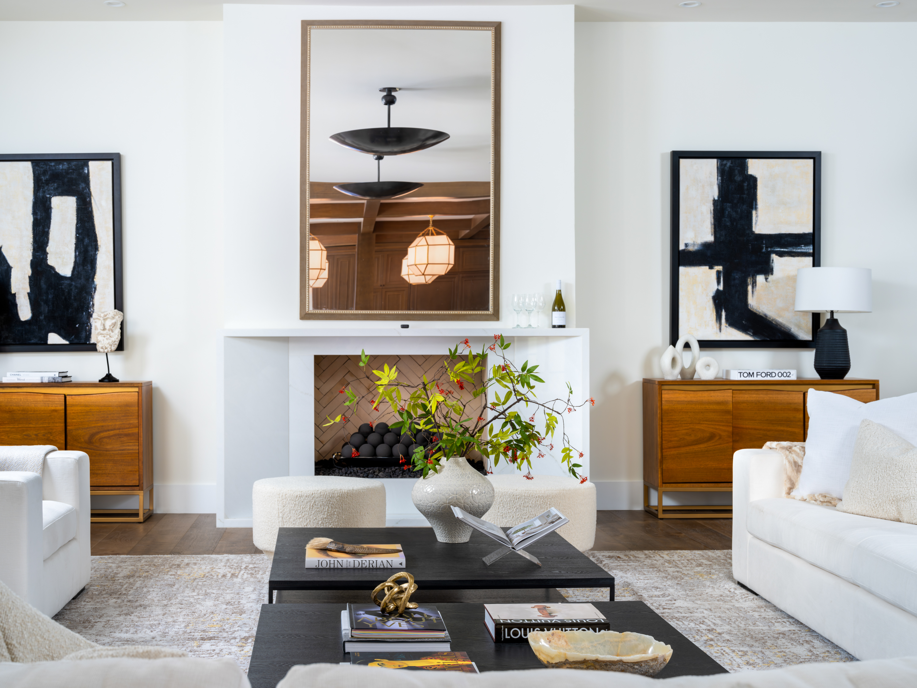 Living Room at a Stately Mediterranean revival home in Las Vegas (8833 GL) — exposed wood ceiling beams, brass pendant lanterns, cream sofas, dark coffee tables.