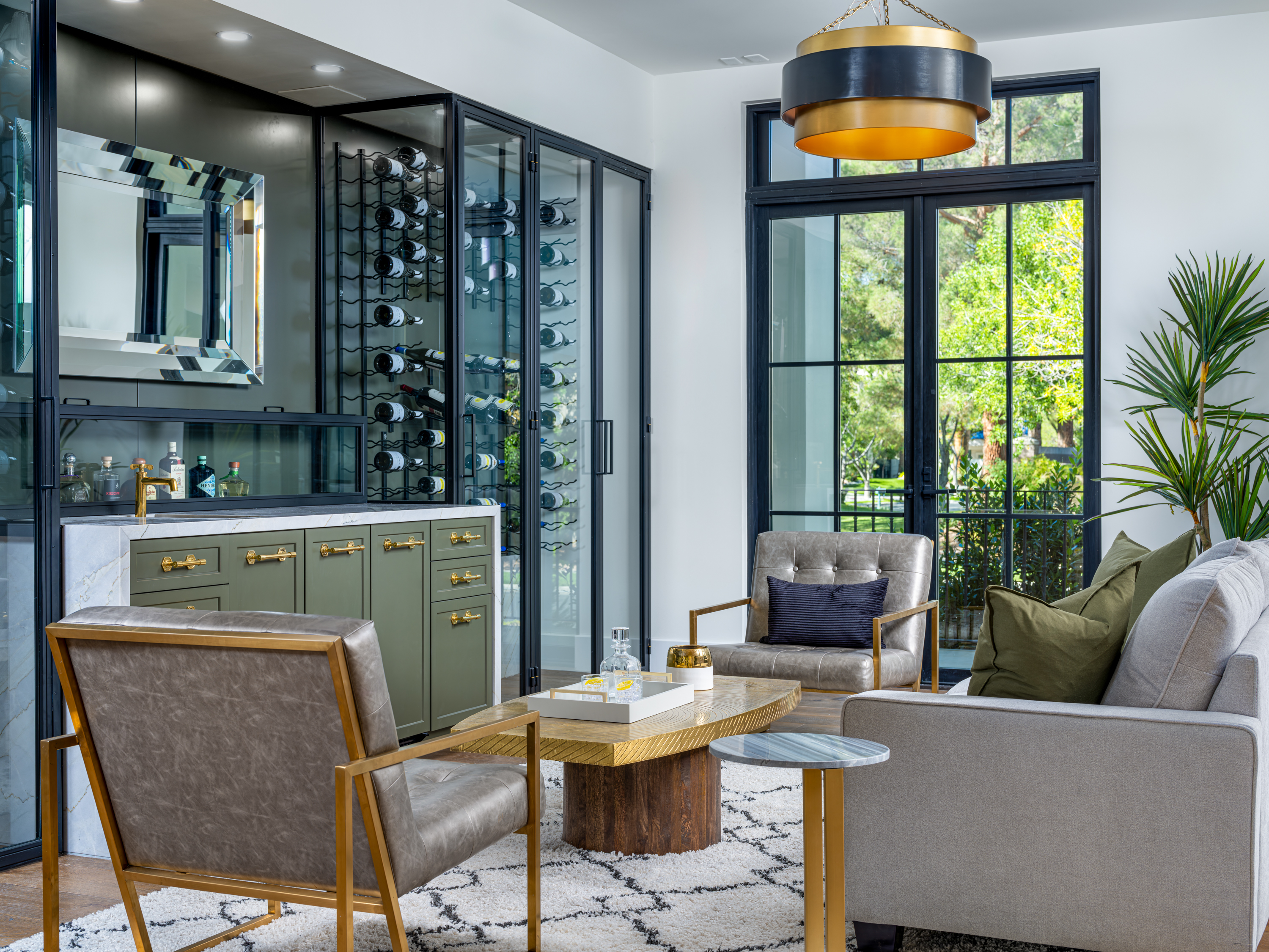 Bar at a Stately Mediterranean revival home in Las Vegas (8833 GL) — exposed wood ceiling beams, brass pendant lanterns, cream sofas, dark coffee tables.
