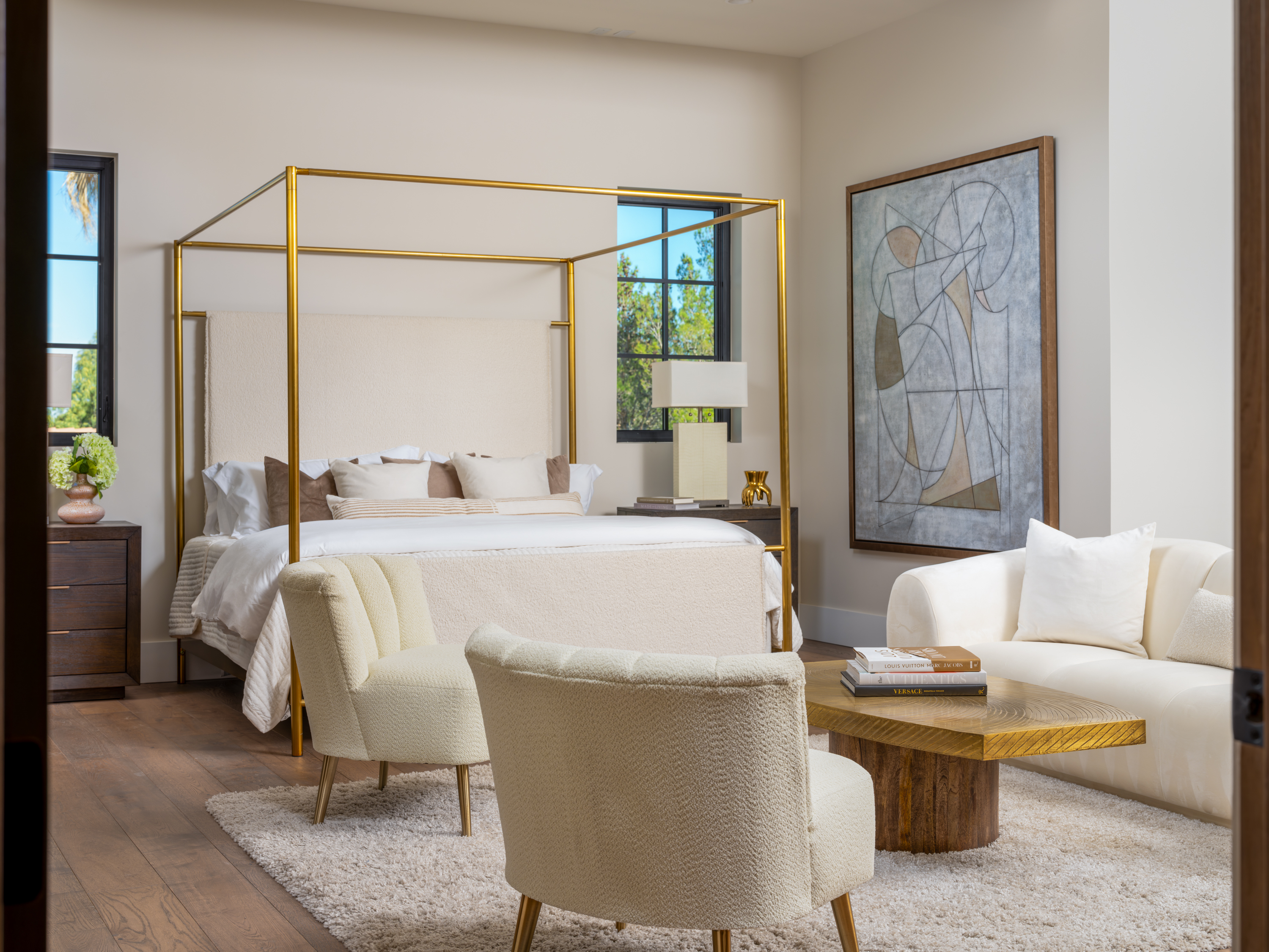 Master Bedroom at a Stately Mediterranean revival home in Las Vegas (8833 GL) — exposed wood ceiling beams, brass pendant lanterns, cream sofas, dark coffee tables.