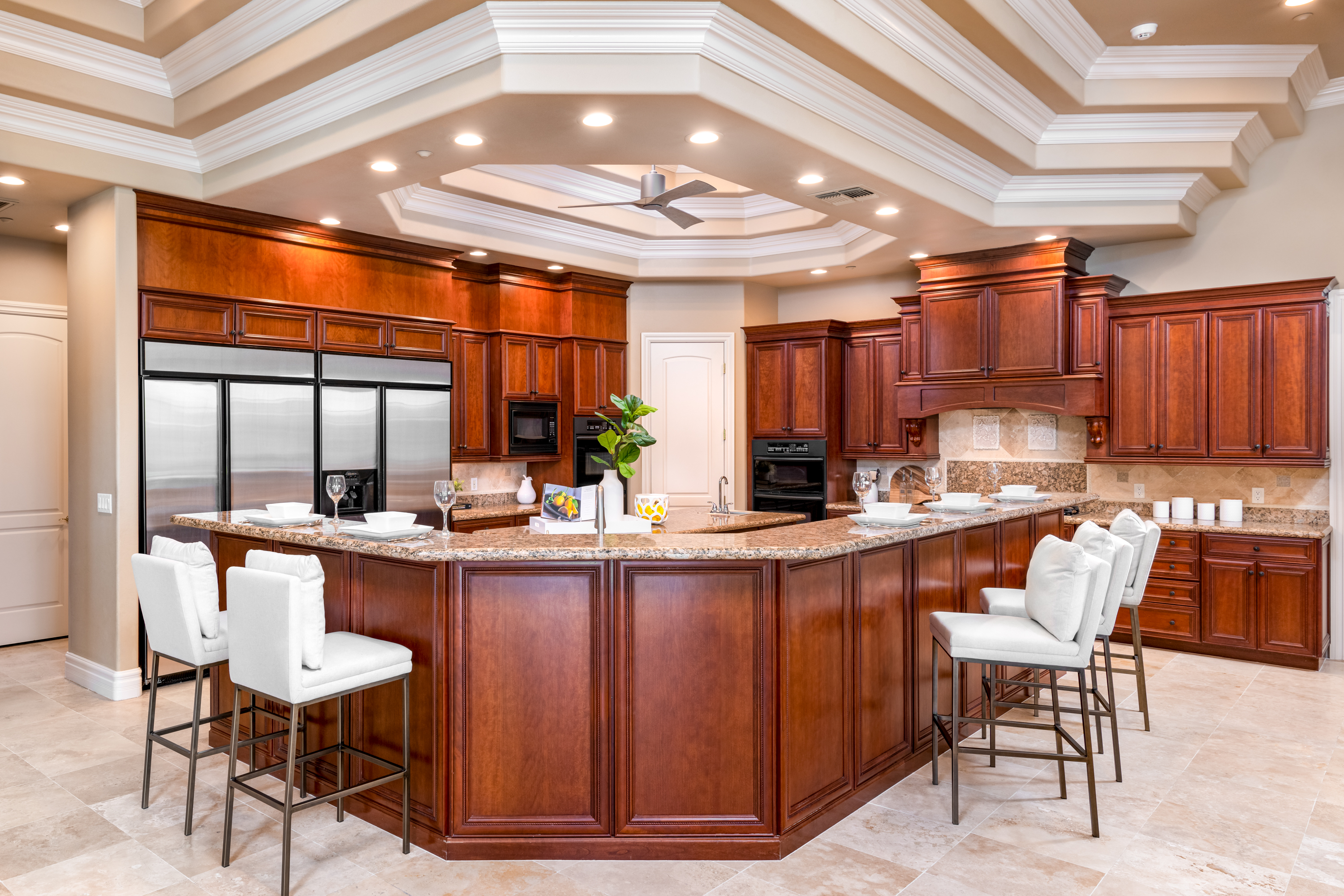 Kitchen at a Stately traditional gentleman's library home in Las Vegas (2297 FA) — cherry bookcases, rolling library ladder, tufted cream sofa, antique tripod clock.