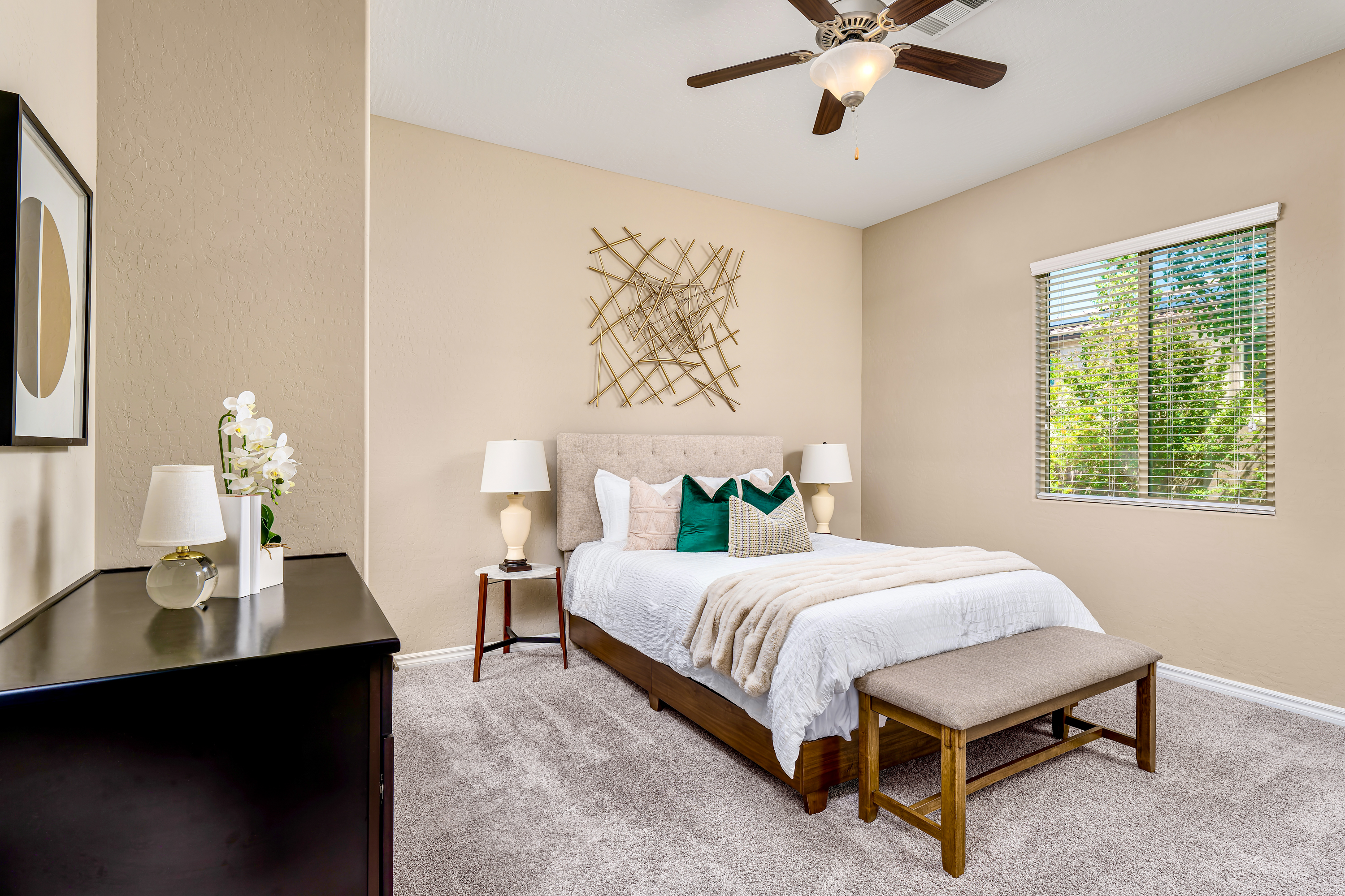 Bedroom at a Stately contemporary Moroccan-influenced home in Las Vegas (2818 PSA) — navy velvet chairs, geometric blue-white art, gold accents, marble tile.