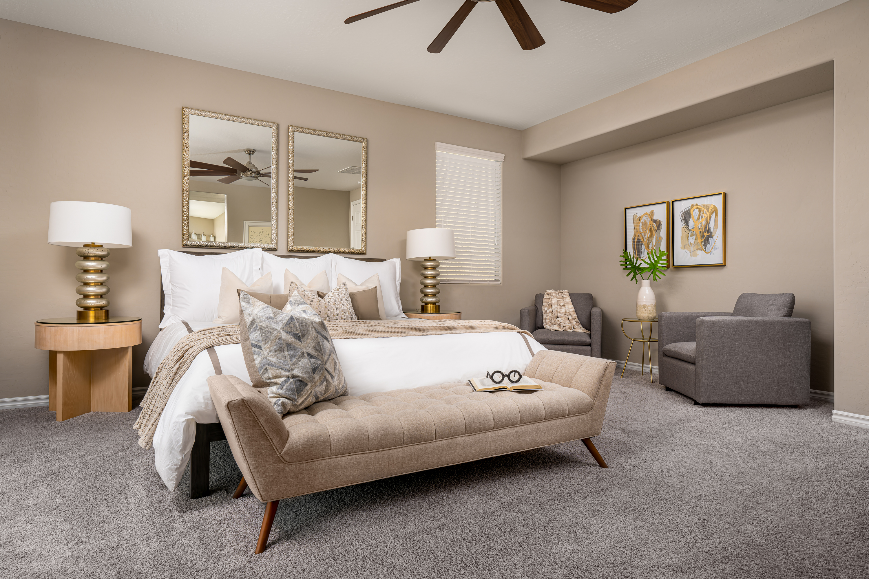 Master Bedroom at a Stately contemporary Moroccan-influenced home in Las Vegas (2818 PSA) — navy velvet chairs, geometric blue-white art, gold accents, marble tile.