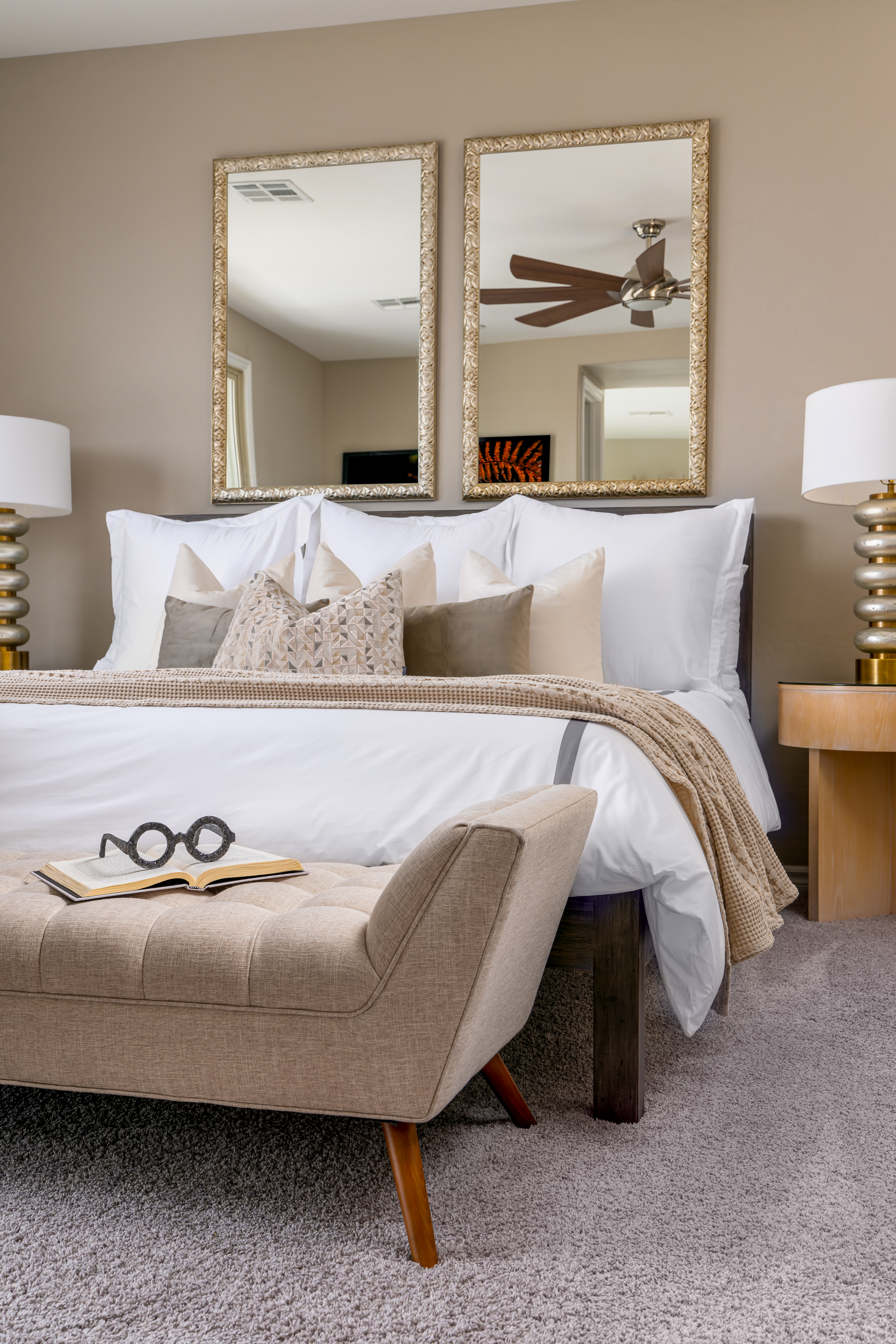 Master Bedroom at a Stately contemporary Moroccan-influenced home in Las Vegas (2818 PSA) — navy velvet chairs, geometric blue-white art, gold accents, marble tile.