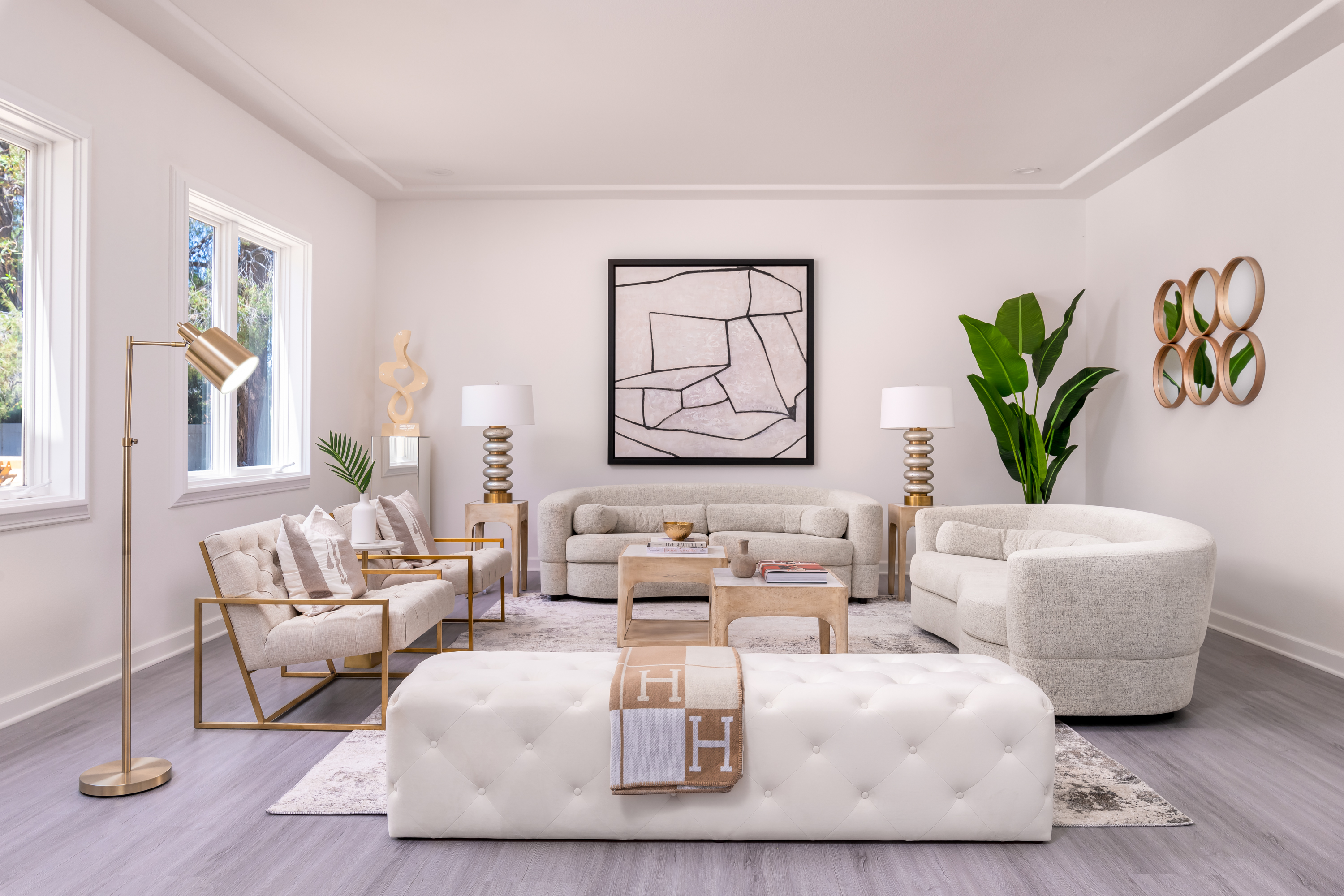 Living Room at a Stately modern luxury fireplace centerpiece home in Las Vegas (3540 ETL) — herringbone tile fireplace, reclaimed wood drum table, bouclé chairs, arched w