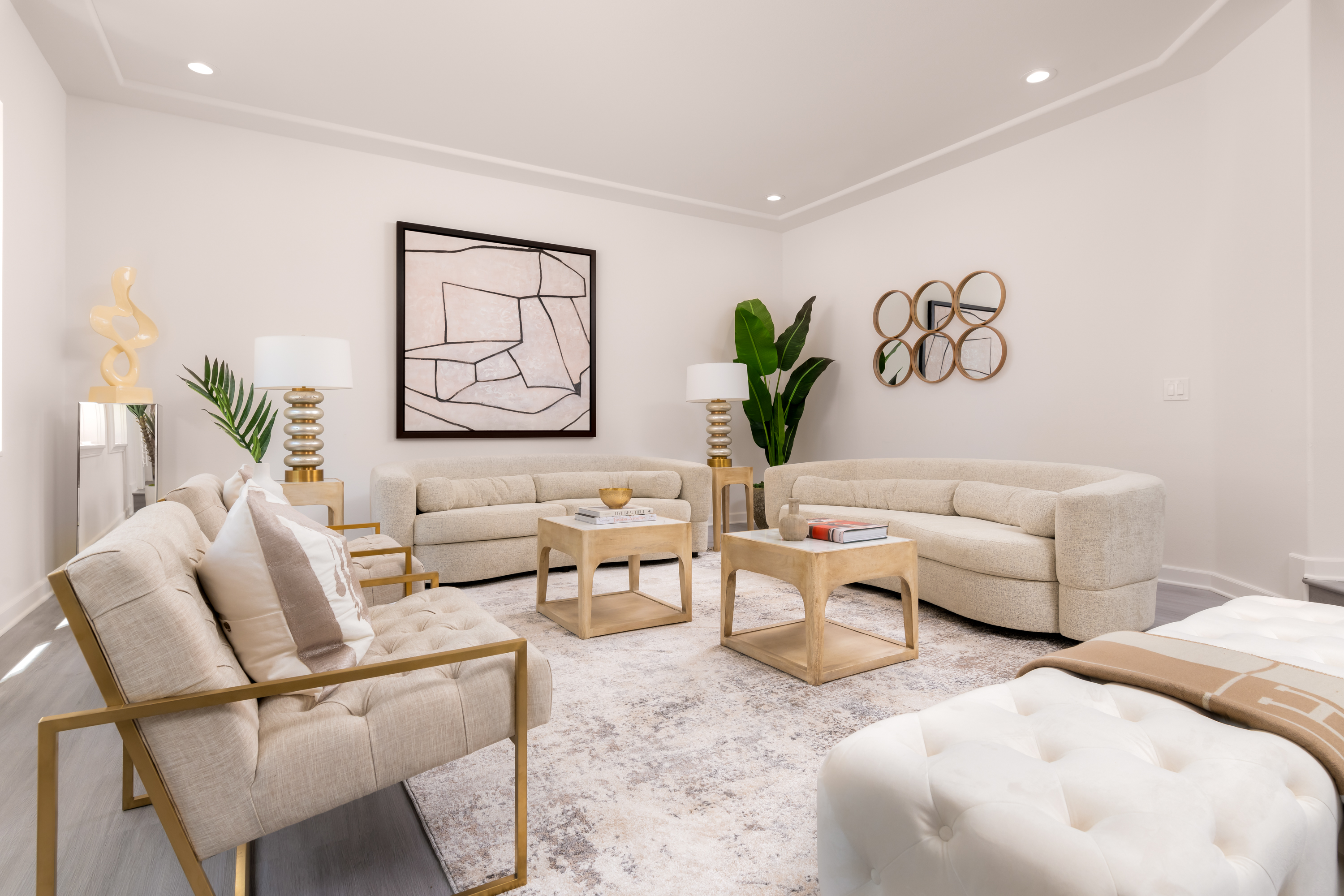 Living Room at a Stately modern luxury fireplace centerpiece home in Las Vegas (3540 ETL) — herringbone tile fireplace, reclaimed wood drum table, bouclé chairs, arched w