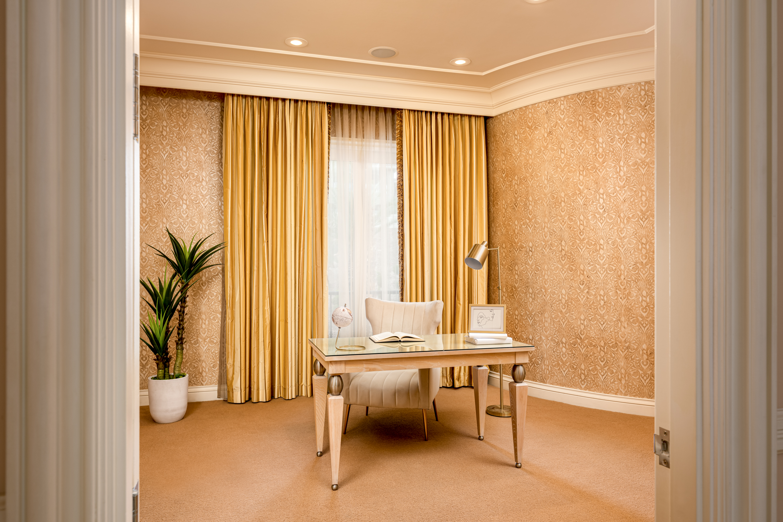 Office at a Stately glam estate home in Las Vegas (5114 SHD) — two-story curtains, paired gold-base ottomans, marble fireplace, panoramic view.