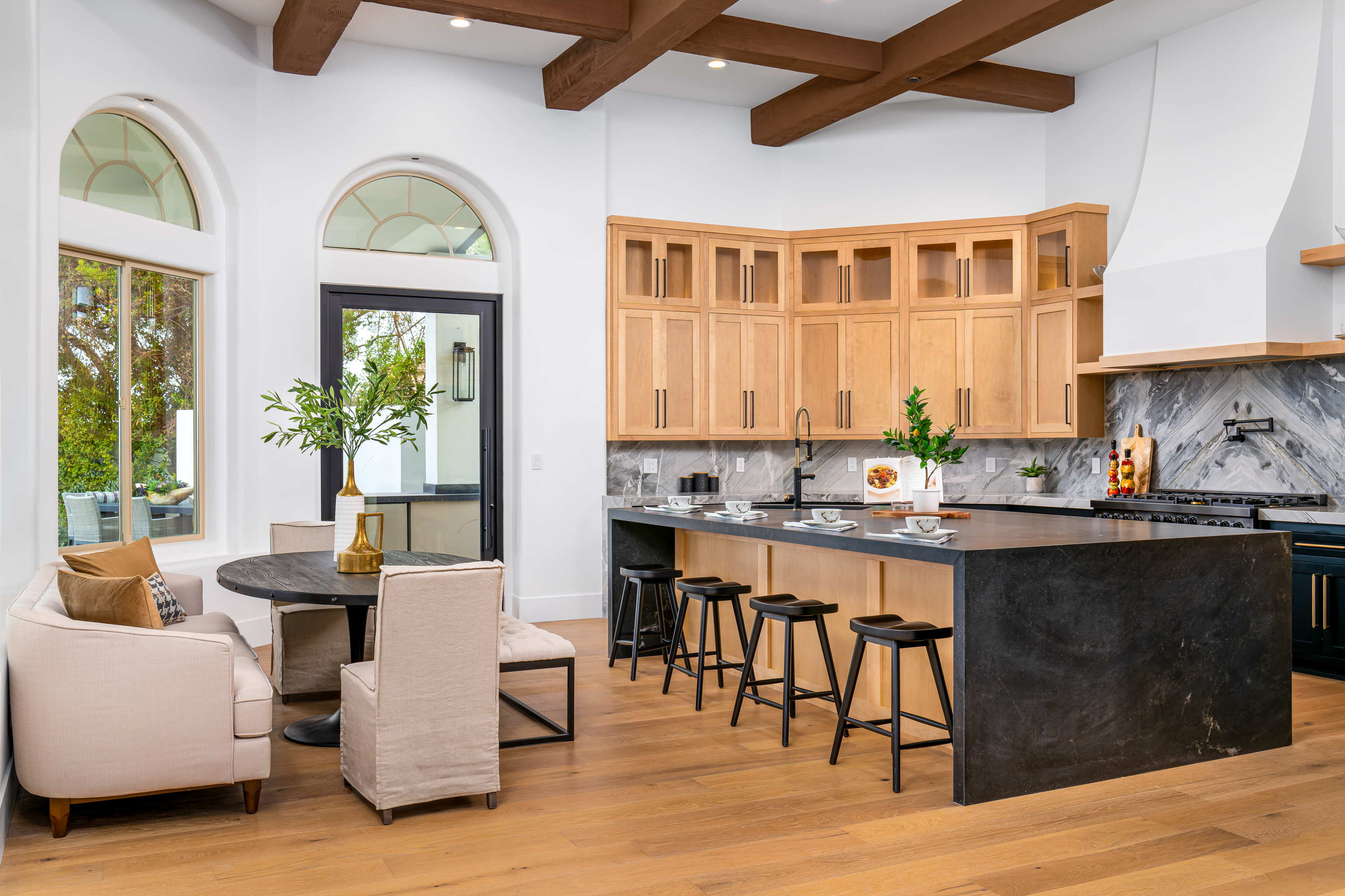 Kitchen Nook at a Stately library sitting room home in Las Vegas (9 YC) — Sputnik chandelier, wood ladder bookcase, channel-tufted swivel chairs, shag rug.