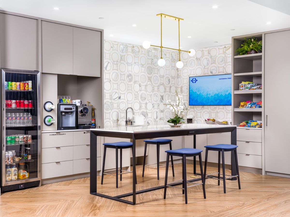 JAMS Cafe at JAMS Dallas, Sherry Lane Place — counter island with blue stools, brass chandelier, marble ring-pattern backsplash, snack shelves, beverage cooler.