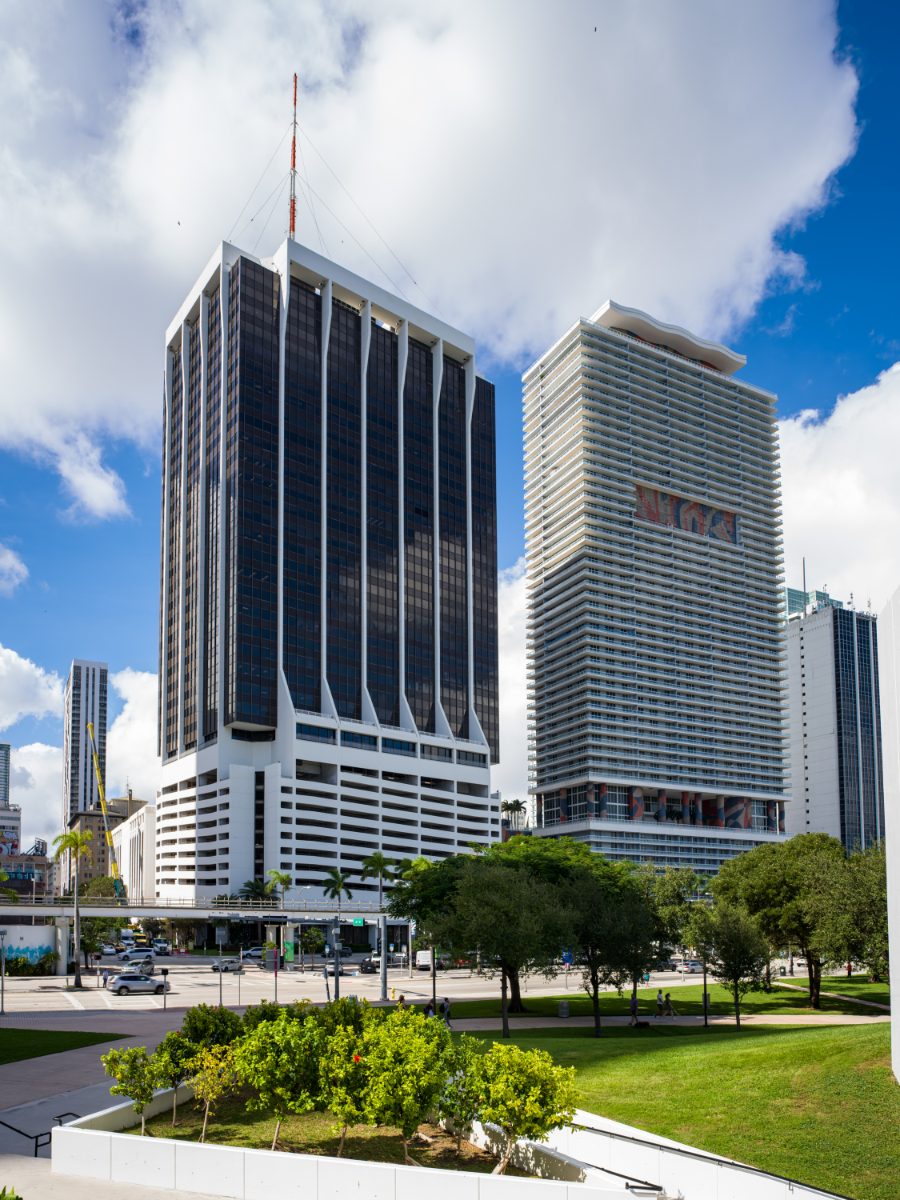 One Biscayne Tower in downtown Miami — a 39-story dark-glass office tower with white gothic-buttress fins, home to the JAMS International Arbitration Center.